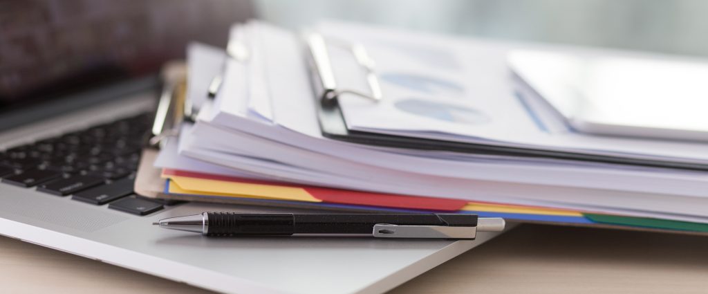 A stack of papers and clip boards.