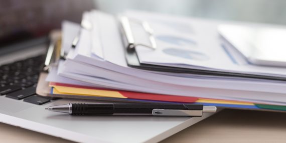 A stack of papers and clip boards.