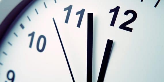 Closeup of hands on clock face